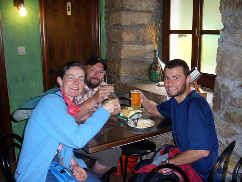 having a drink at the first bar after 100 km to santiago marker