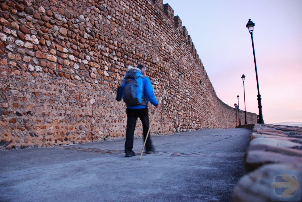 Pilgrim in morning light at ancient walls of Galisteo